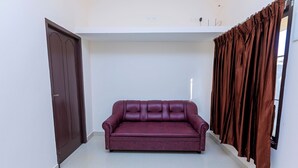 A room with a dark brown door, a dark brown curtain, and a dark brown sofa. - Welcome Grand Private Pool Villa (Vanur)