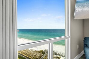 A room with a large window overlooking a beach and ocean. - Shoreline Towers 2114- Completely Renovated 2 BR with Free Beach Service for 2! (Destin)