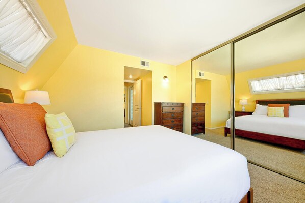 A hotel room with a large bed, a dresser, a mirror, and a window. - Great Reviews, Walk To Beach, Amazing Location W/ Parking! (San Diego)