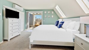 A bedroom with a bed, a dresser, a TV, and a skylight. - Perfect For Families, Steps To Beach, Close to Everything! (San Diego)