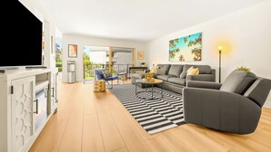 A modern living room with a sofa, coffee table, and TV stand. - Pet Friendly 2 bedroom in Point Loma Overlooking Kellogg Beach - Stay for 30 days! (San Diego)