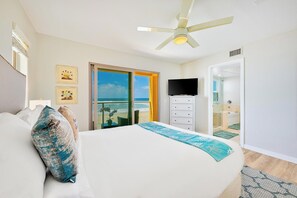 A bedroom with a bed, a television, a ceiling fan, and a view of the beach. - Beachfront, Endless Sunset Views, Amazing Location W/Parking! (San Diego)