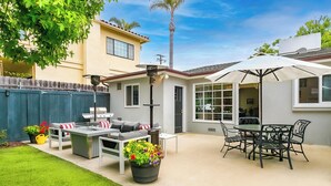 A backyard patio with a grill, outdoor furniture, and potted plants. - Great for Families, Easy Walk to Beach, Pet Friendly! (San Diego)