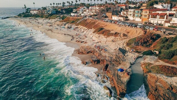 A coastal town with a beach, rocky shoreline, and residential buildings. - Great for Families, Easy Walk to Beach, Pet Friendly! (San Diego)