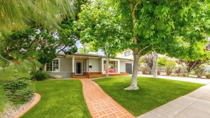 A residential property with a well-maintained lawn, a brick pathway leading to the entrance, and mature trees providing shade. - Great for Families, Easy Walk to Beach, Pet Friendly! (San Diego)