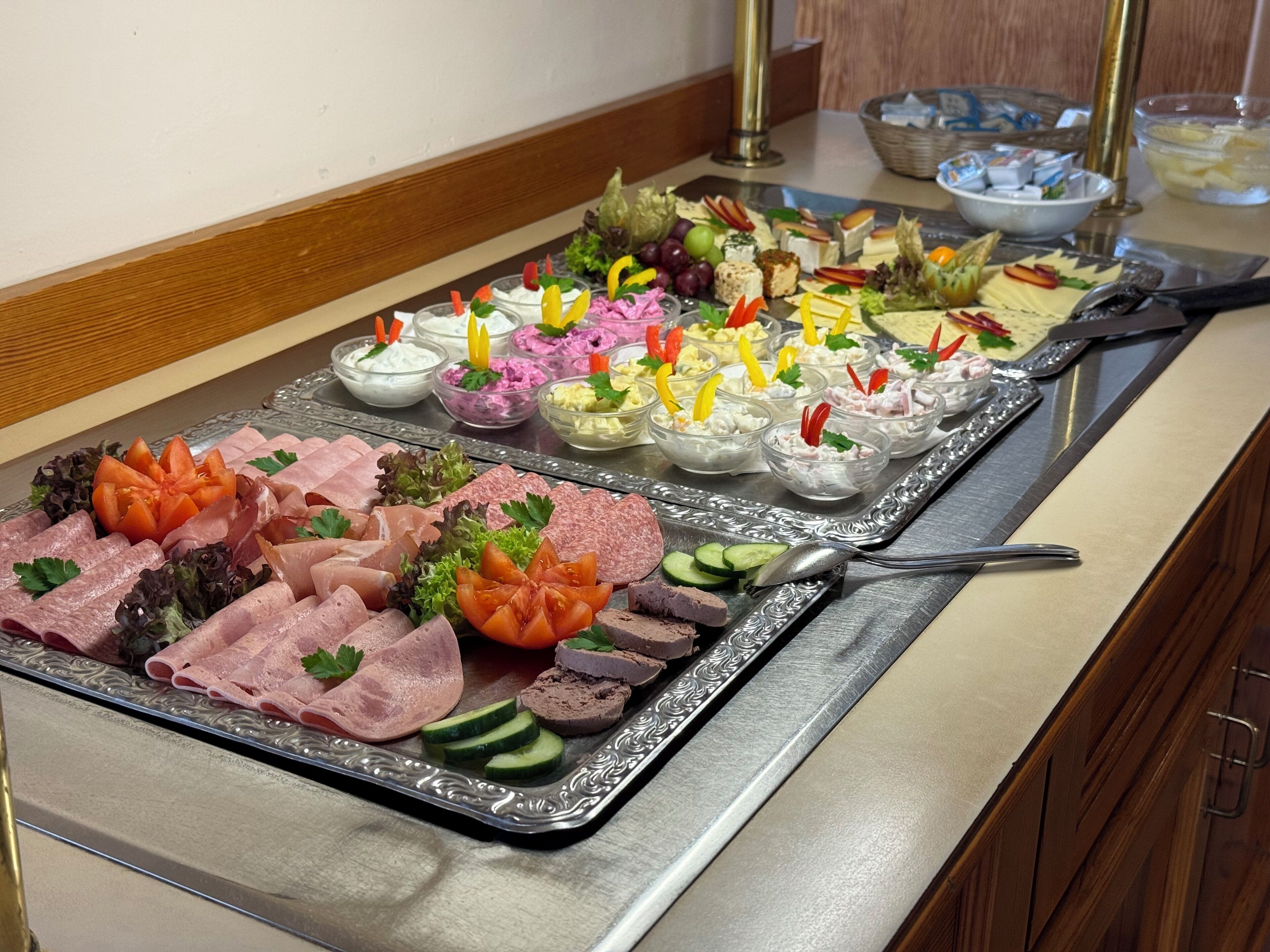 A buffet with various food items and garnishes.