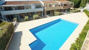 A residential building with a swimming pool, a tiled patio, and a fenced garden area. - Charming Accommodation With Pool in Viddalba (Viddalba)