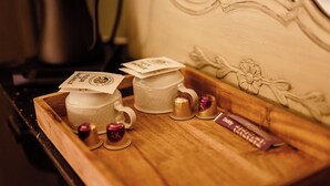 A tray with two white cups, a teapot, and a chocolate bar on a wooden surface. - Château de la Grange Moreau - Chambre Claude de Dommaigné (Vallon-sur-Gée)