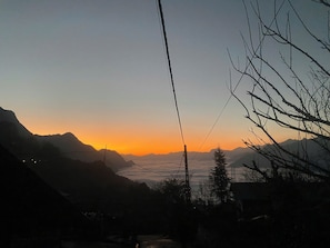 A mountainous landscape at sunset with a clear sky.