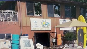Een gebouw met een bord waarop een café en een winkel worden aangeboden.