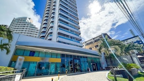 A modern hotel with a curved facade, large glass windows, and a prominent entrance. - Ahead Ponta Negra #602 - Apartment by Carpediem (Natal)