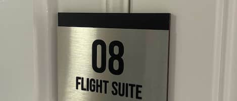 A door with a sign indicating '08 FLIGHT SUITE.'