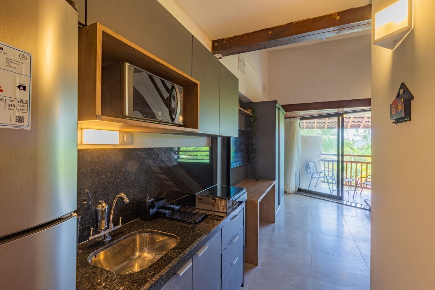 A modern kitchen with a granite countertop, stainless steel appliances, and a built-in oven.