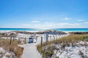 A sandy beach with a wooden boardwalk leading to the water, surrounded by dunes and signs indicating private property. - 🏖️Grayton Beach Gem | Short Walk to Private Beach | Pool+Bikes | House of Blues (Santa Rosa Beach)