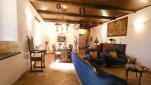 A rustic living room with a fireplace, wooden ceiling, and tiled floor. - Scappo in Umbria, Antico casale (Umbria)