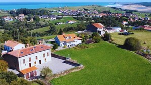 A residential area with houses, a large green field, and a view of the sea. - InfinityCoast 3 byFidalsa (Piélagos)