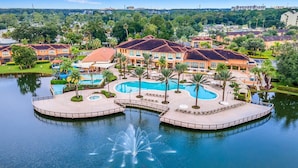 Een resort met een groot centraal zwembad, meerdere kleinere zwembaden en een fontein.