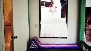 A room with a bed, a window with a curtain, and a door. - greenteakhouse (Bangkok)