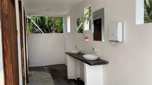A modern bathroom with two sinks, a mirror, and a hand dryer. - Hot Chipilin El Paredon (Sipacate)