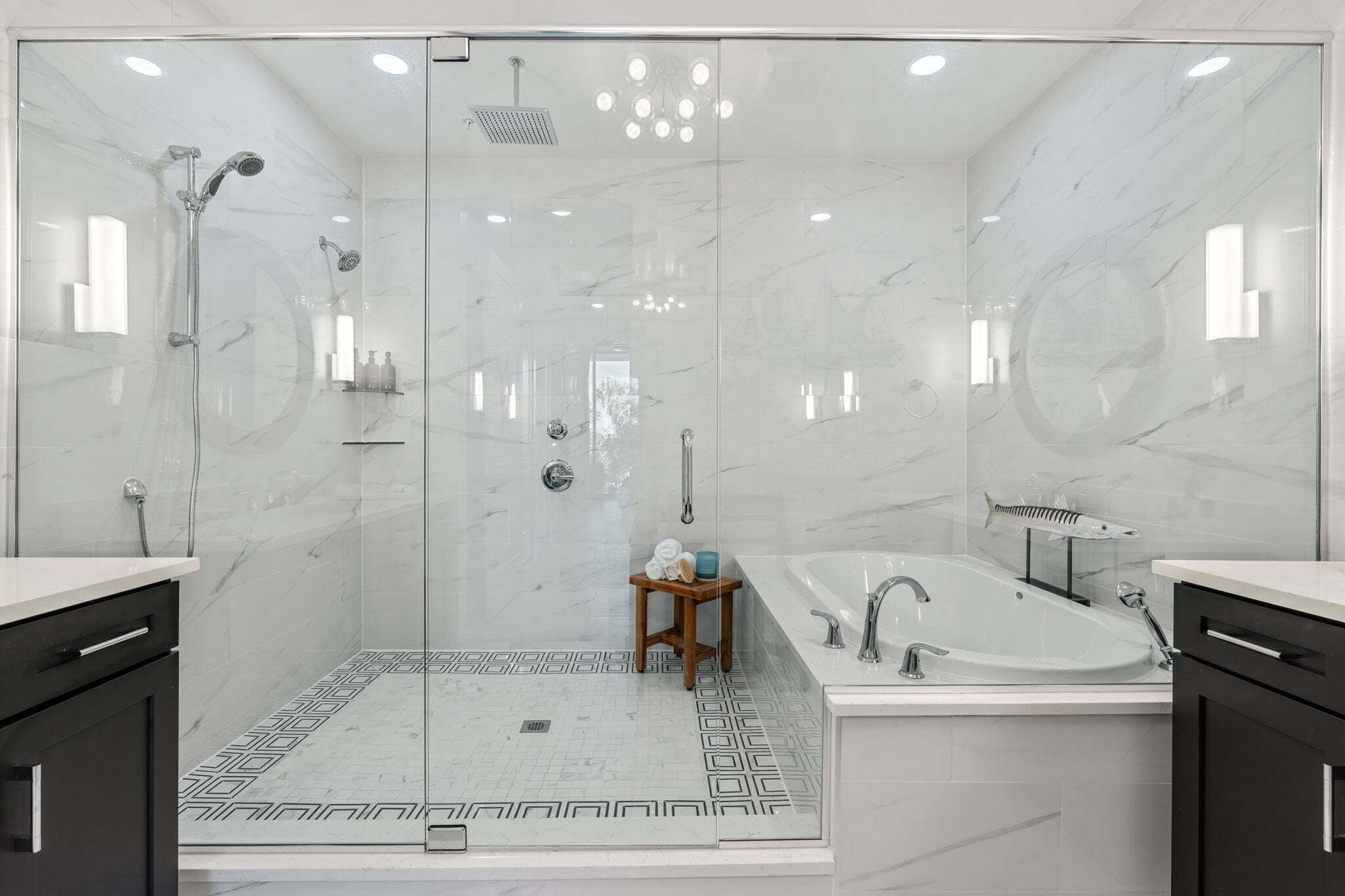 A modern bathroom with a glass-enclosed shower, a freestanding bathtub, and a vanity with a mirror.