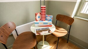 A corner room with a round table, two wooden chairs, and a window. - Stay Hush (Edinburgh)