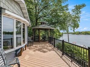 A wooden deck with a gazebo, outdoor seating, and a view of a lake. - Lakefront House Great for Bachelorette Parties and Reunions (Six Lakes)