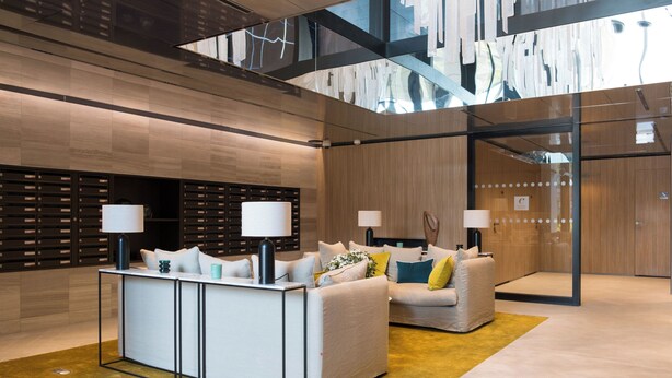 A modern lobby with a reception desk, sofas, and a glass wall. - Zenao Appart'hôtels Auteuil (Paris)