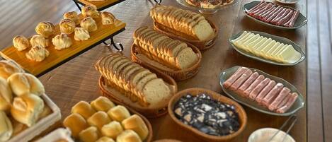 A buffet table with various food items and utensils.