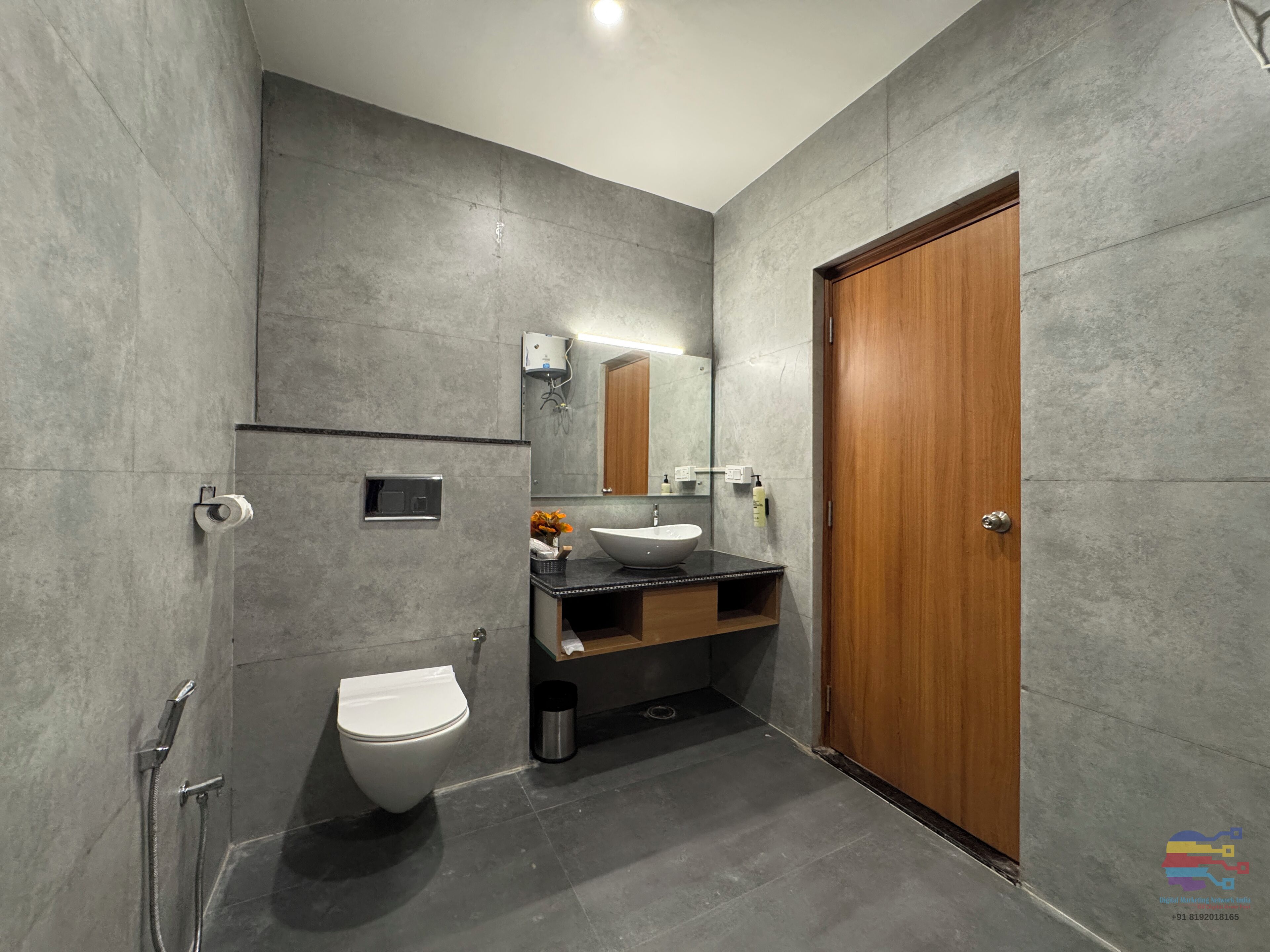 A modern bathroom with a toilet, sink, and shower.