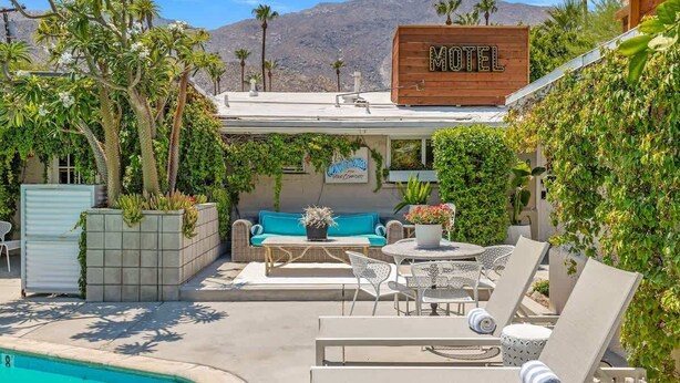 A motel with outdoor seating, a pool, and a mountain backdrop. - Adobe Cottage; Unit A (Palm Springs)