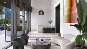 A modern interior with a central seating area, a large window, and a plant. - Downtown Miami Apt: Pool, Skyline Views, Gym Access (Miami)
