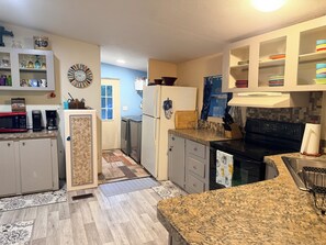 A modern kitchen with granite countertops, stainless steel appliances, and a variety of storage cabinets. - Nature Cabin Itchetucknee Springs Private Access 
~ Nature Lovers Only (Fort White)