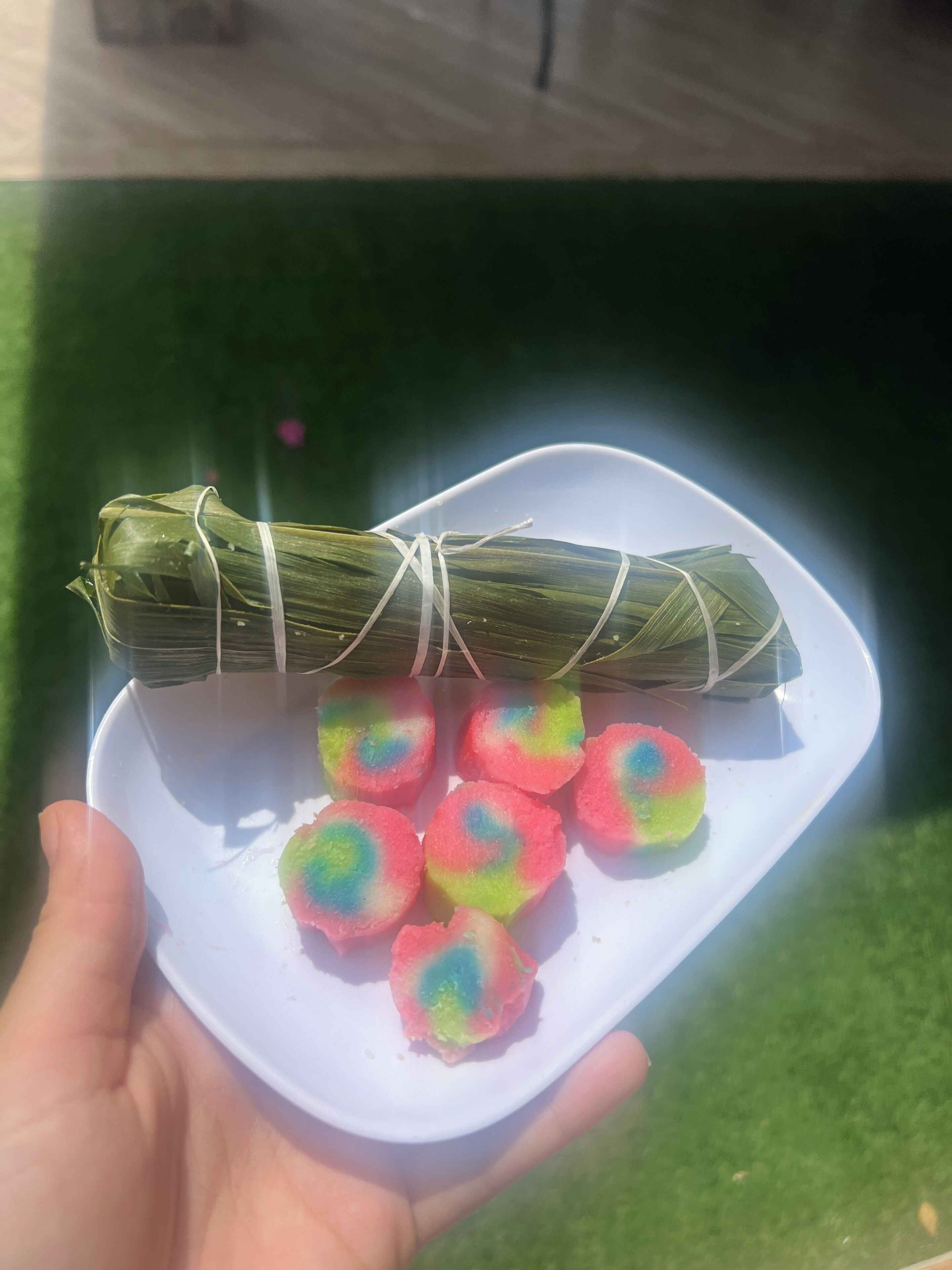 A plate with a wrapped item and colorful food items.