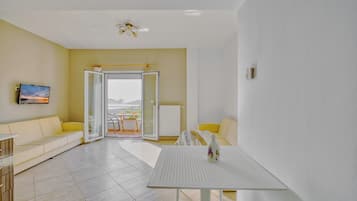 Family Apartment, Balcony, Sea View | Living area | 32-inch flat-screen TV with cable channels
