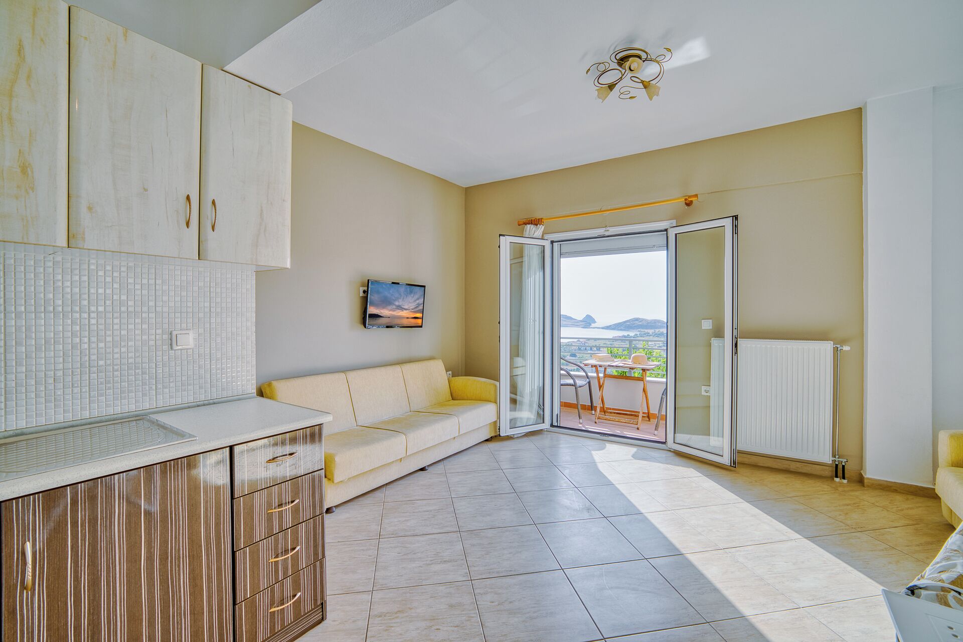 Family Apartment, Balcony, Sea View | Living area | 32-inch flat-screen TV with cable channels