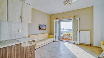 Family Apartment, Balcony, Sea View | Living area | 32-inch flat-screen TV with cable channels