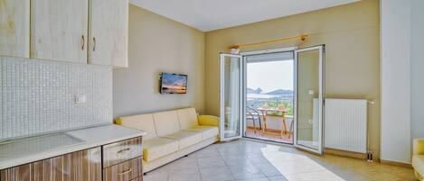Family Apartment, Balcony, Sea View | Living area | 32-inch flat-screen TV with cable channels