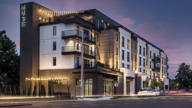 A modern hotel with a prominent 'MUSE' sign, multiple balconies, and a well-lit facade. - Downtown Condo · Walk to Broadway · Free Parking (Nashville)