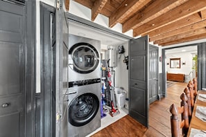 Laundry Room | Stacked Washer & Dryer | Hardwood Floors