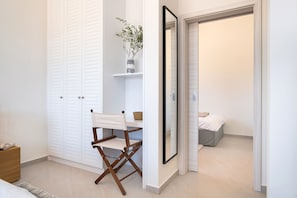A bedroom with a bed, a dresser, a chair, and a mirror. - 5* Luxury Seaview Villa Plant 5 with pool (Novalja)