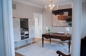 A room with a white laundry station, a dark wooden table with two lamps, and a large abstract painting on the wall. - Stylish 5 bedroom/3b close to HPU, Wyndham & FM! (Jamestown)