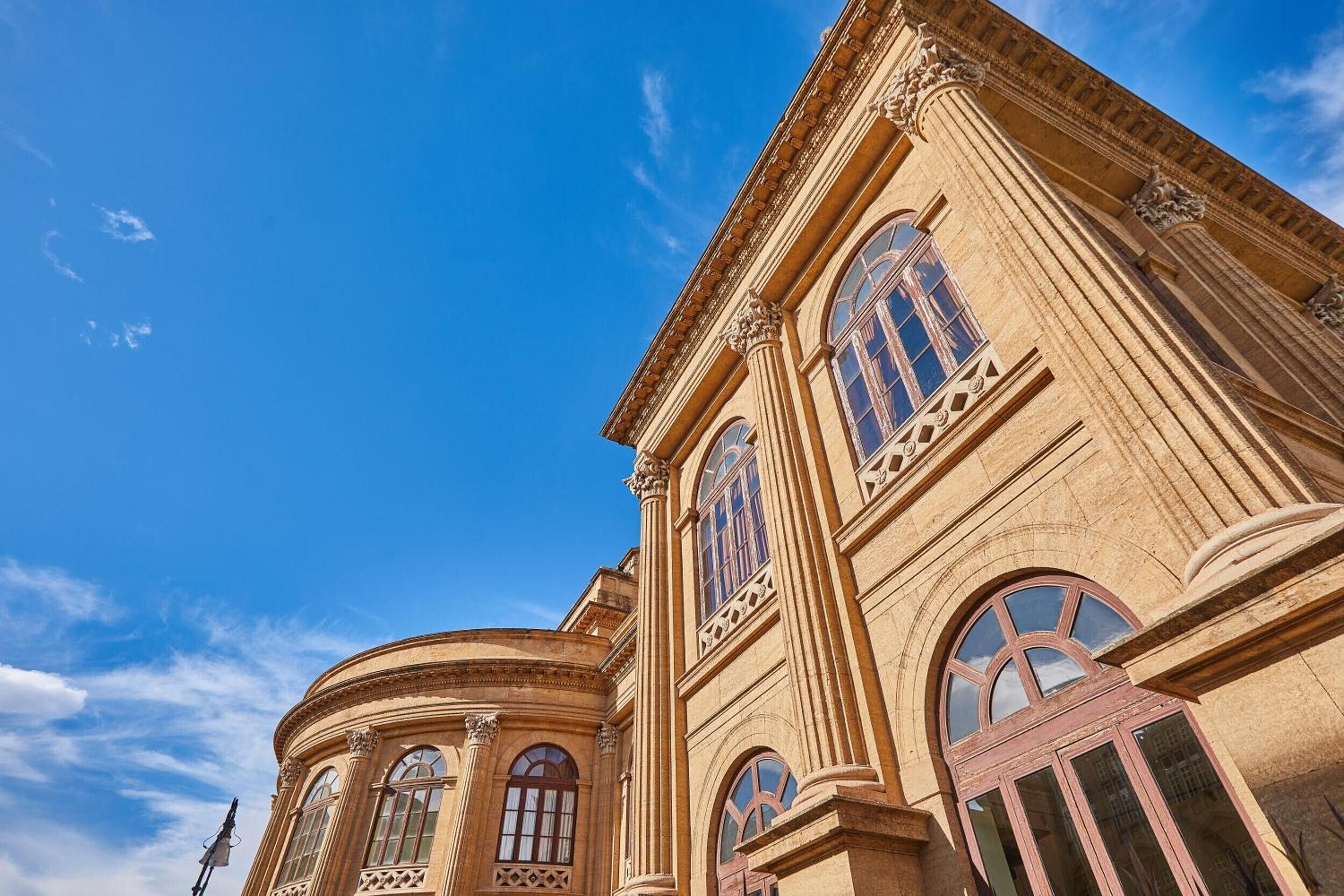 A classical building with arched windows and ornate columns.