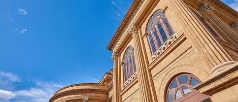 A classical building with arched windows and ornate columns.