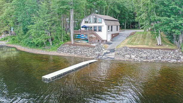 A lakeside cabin with a dock, surrounded by dense forest. - Peaceful Point Waterfront Dogs Welcome, Near Acadia National Park & Bar Harbor (Eddington)
