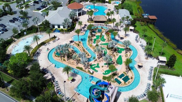 Vista aerea di un resort con diverse piscine, un parco acquatico e una spiaggia.