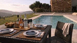 A dining table set with plates, cutlery, and bottles, overlooking a pool and mountains. - Villa with private pool between sea and mountains, quiet setting (Appietto)