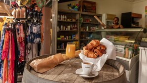 Una mesa con croissants, un vaso de zumo de naranja y una taza de café.