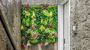 A narrow outdoor corridor with a textured wall and a door on the right. - Arcade, Neon Lights, 70 min Banff , Local Coffee (Calgary)