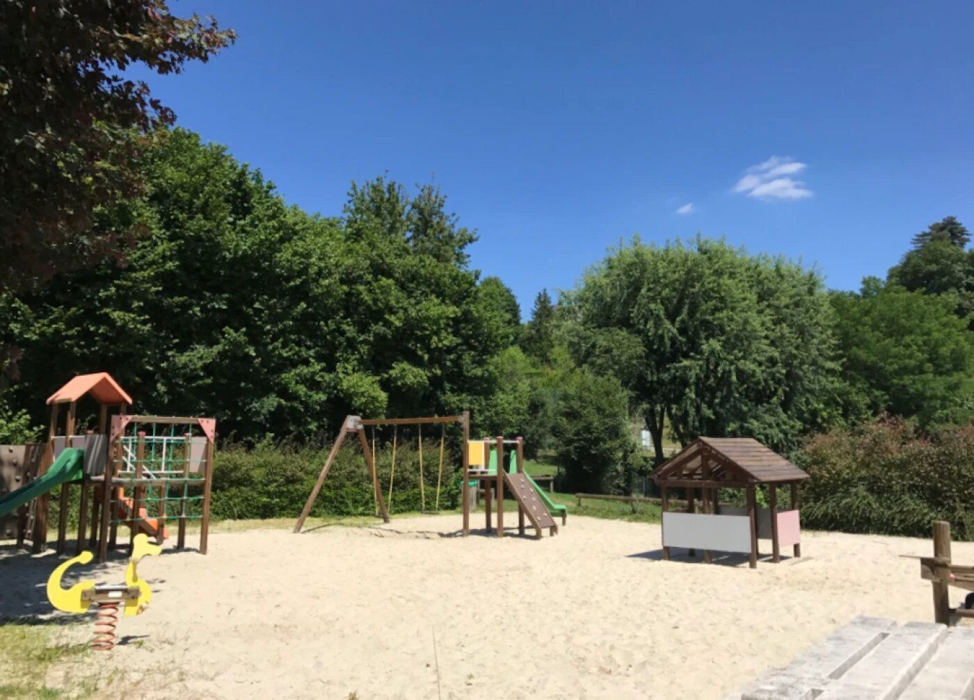 A playground with swings, slides, and climbing structures.