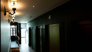 A hallway with a wooden floor, a staircase, and a door at the end. - King Bed & Private Soaking Tub (Ciudad de México)